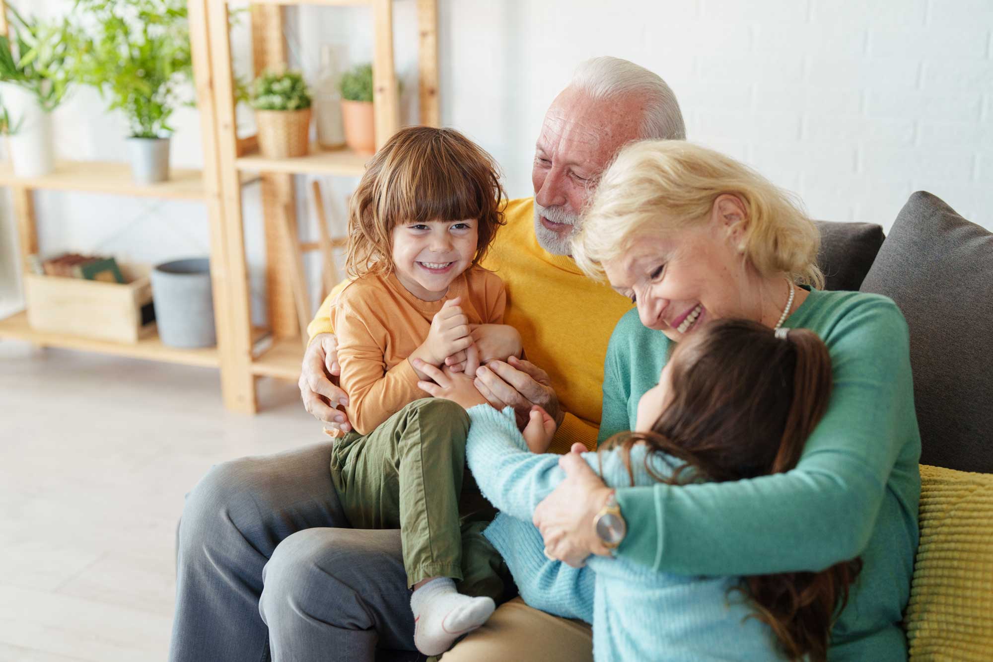 joyful-caucasian-grandparents-laughing-and-bonding-with-their-grandchildren-in-a-well-lit-cozy-home-environment